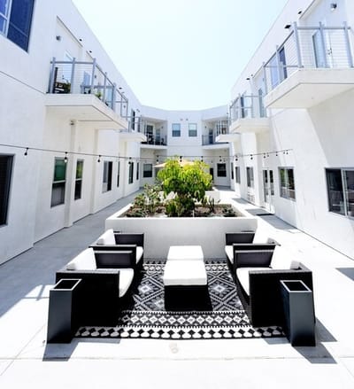 Outdoor seating area in a sunlit courtyard