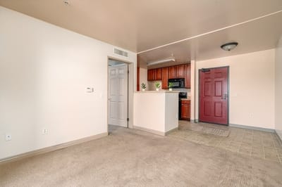 Interior view of a kitchen and living area in a senior apartment