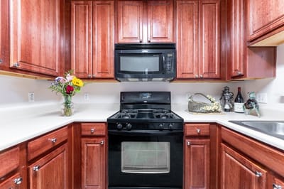Interior kitchen with wood cabinets and appliances