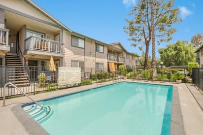 Outdoor pool area at Woodside Senior Apartments