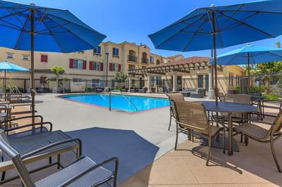 Outdoor pool area with umbrellas and seating