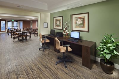 Common area with dining tables and a desk