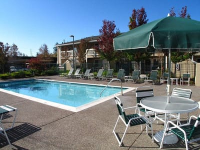 Outdoor pool area with lounge chairs and umbrellas