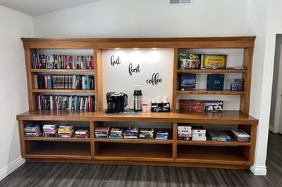 Coffee station with bookshelves in a communal area
