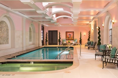 Indoor pool area with lounge chairs and artwork