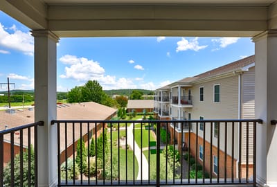 View of landscaped courtyard and surrounding buildings from a balcony