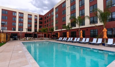 Outdoor pool area with lounge chairs and decorative umbrellas
