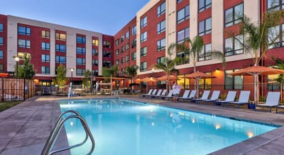 Outdoor pool area with lounge chairs and shaded seating