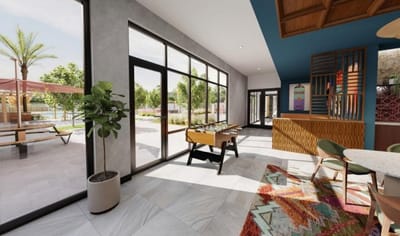 Bright interior common area with large windows and decor
