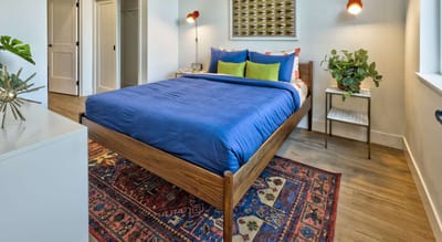 Cozy resident room with a blue bedspread and decorative accents