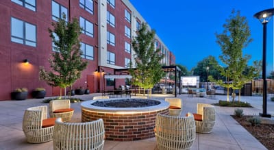 Outdoor seating area with a fire pit and trees