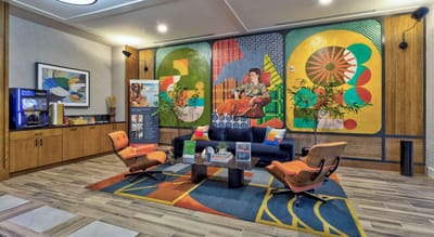 Brightly decorated common area with seating and art