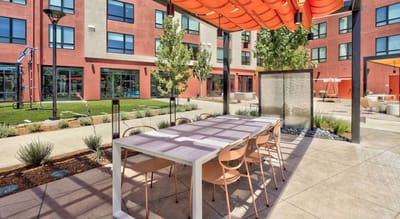 Outdoor dining area with modern furniture and landscaping