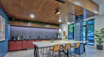 Modern kitchen area with seating and plants