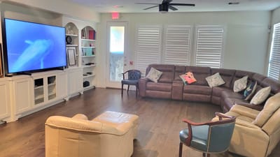 Bright common area with seating and a TV
