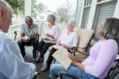 Residents enjoying conversation on a porch