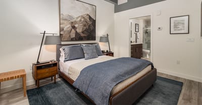 A well-decorated private resident room with a bed and bathroom
