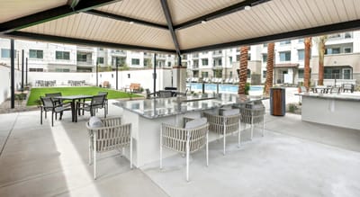 Outdoor space with seating and shade near the pool