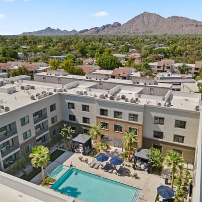 Aerial view of the facility with a pool and outdoor space
