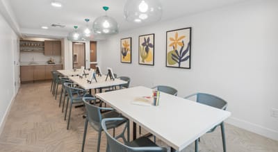 Bright activity room with tables and artwork