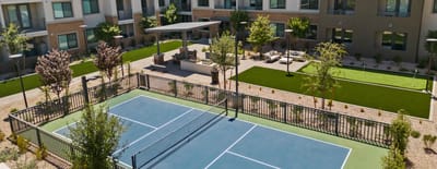 Aerial view of an outdoor tennis court and gardens