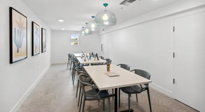 Bright common area with tables and artwork