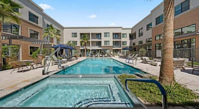 Outdoor pool area with lounge chairs and umbrellas