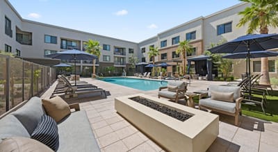 Outdoor pool area with lounge chairs and umbrellas