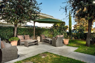 Outdoor seating area with shaded patio furniture