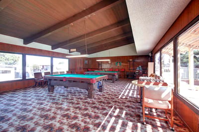 Bright activity room with a pool table and seating
