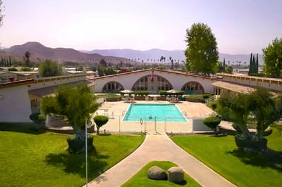 Outdoor pool area with seating and landscaping