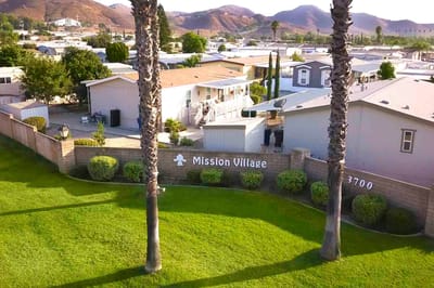 Aerial view of Mission Village with green lawn and homes