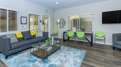 Bright common area with seating and a desk