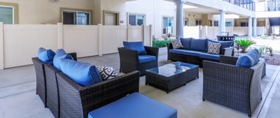Outdoor seating area with blue cushions and plants