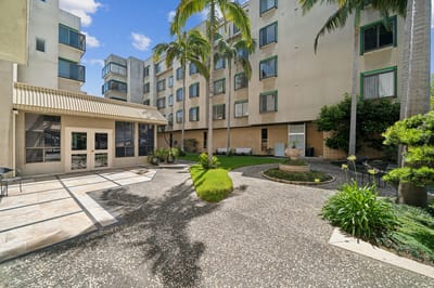 Outdoor courtyard with palm trees and seating areas