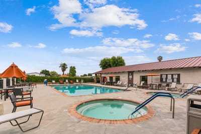 Outdoor pool area with seating and spa