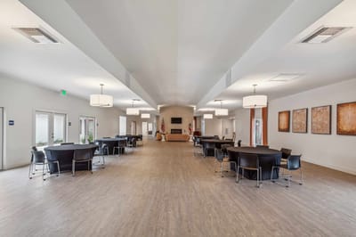 Bright dining room with tables and chairs arranged