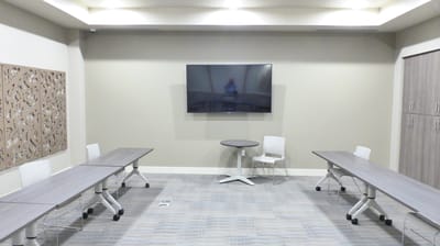Interior meeting room with tables and television