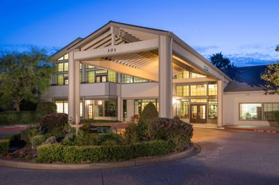 Exterior view of the Oakmont Gardens facility at dusk
