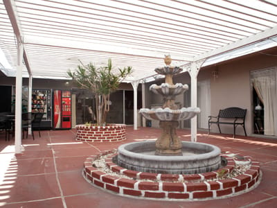 Courtyard with a fountain and seating area.