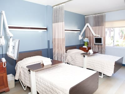 Two hospital beds in a patient room.