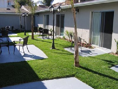 Outdoor seating area with grass and walkways.
