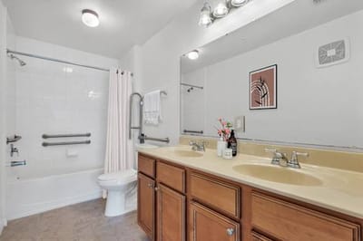 Spacious bathroom with dual sinks and tub