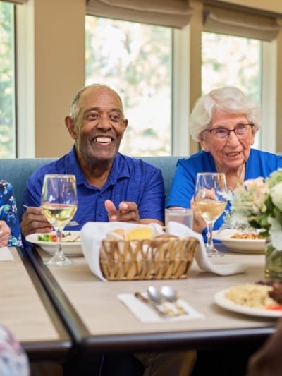 Residents enjoying a meal together in the dining room