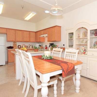 Bright, tidy dining area with wooden table and chairs
