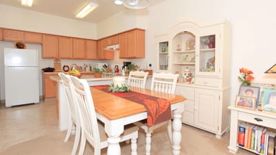 Bright kitchen and dining area with wooden table