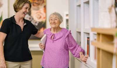 A staff member interacting with a resident inside the facility