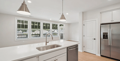 Bright kitchen area with modern appliances and large windows