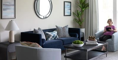 A resident relaxing in a cozy living area with plants