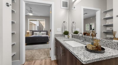 Modern bathroom area with view into a bedroom
